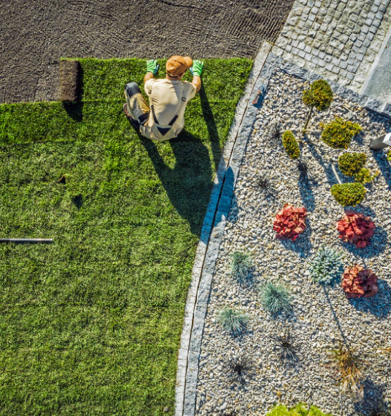 worker installing some fake grass on a patio